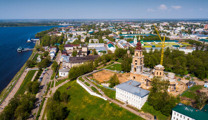 Fototapeta na wymiar Aerial view of Kostroma city on bank of Volga River overlooking Temple Complex of Kostroma Kremlin during reconstruction, Russia