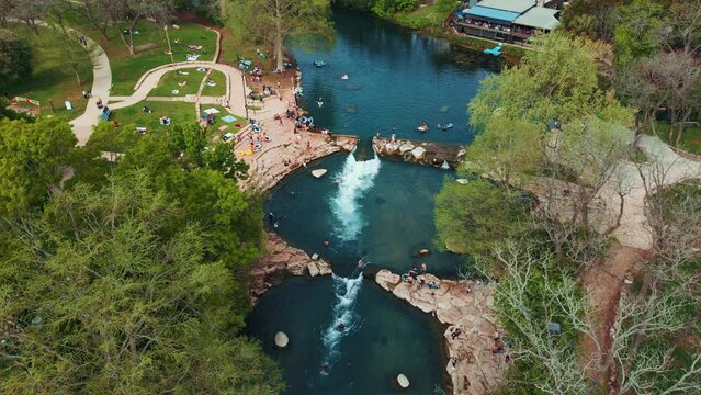 People Enjoying Tube Chute Along San Marcos River in Texas
