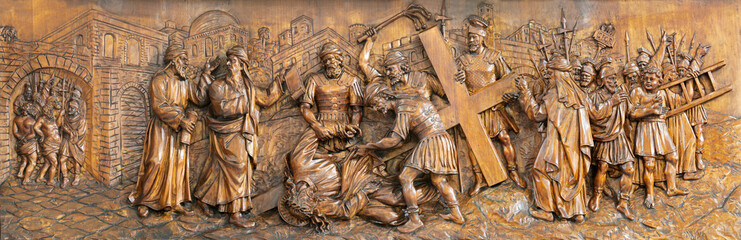 MILAN, ITALY - MARCH 5, 2024: The carved relief of Fall of Jesus under the cross in the church Chiesa di San Camillo by Annibale Pagnoni (1900).