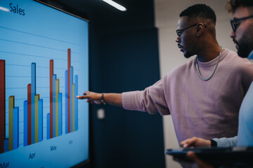 Business people collaborate and analyze statistics, brainstorming and strategizing for success....