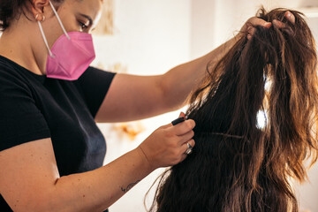 Fototapeta premium Hairdresser doing a woman's long hair