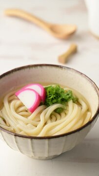 udon noodle with green onion, and fish cake
