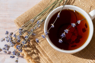 White cup of lavender tea. Mortars of dry lavender alternative medicine. Immunity boosting healthy...