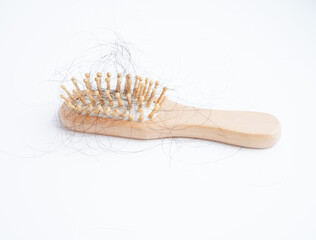 Hair loss fall with comb brush isolated on white background.