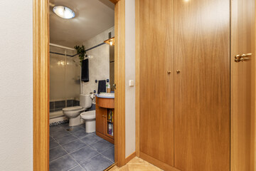 Hallway with built-in wooden wardrobe and access to an en-suite bathroom