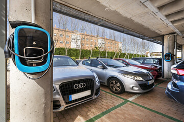 cars parked in a parking lot with electric charging points for vehicles