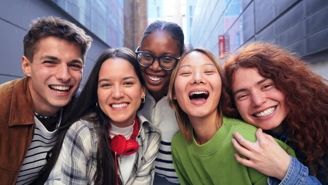 Close up portrait of a group of friends having fun and smiling together. High school students looking at camera with happy expression. Young friendly real people staring front posing for a photo