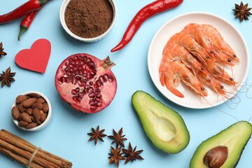 Natural aphrodisiac. Different products and paper heart on light blue background, flat lay