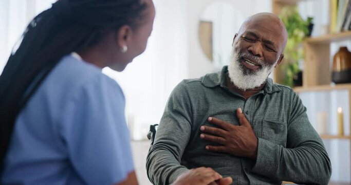 Nurse, senior man and consultation for chest pain in home, healthcare crisis and talk of cardiovascular problems. Black people, caregiver and patient for fear of heart attack and medical care on sofa