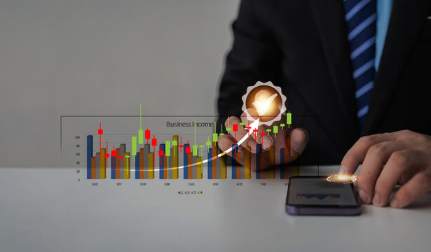 Close-up image of businessman pointing at growth arrow graph and financial network connection Analyze data to increase sales and profit margins to meet business investment goals.
