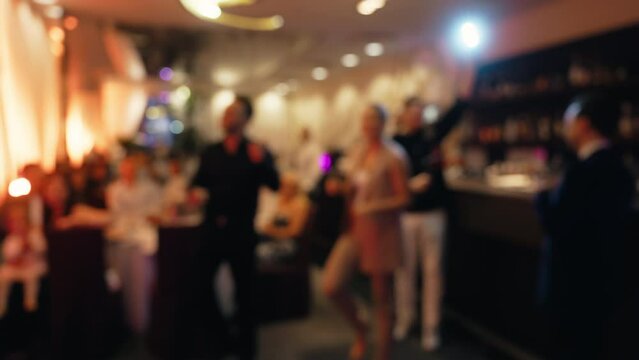 Festive blur: man and woman dancing at lively party event