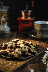 cookies concept in selective focus. Traditional cookies for eid festive called "kuih dam" or "chess cookies" in a dark and dramatic light