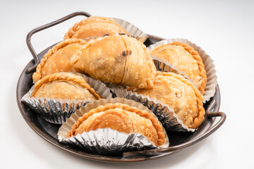 Curry puff on black plate on white background, Curry puff pastry on white background.