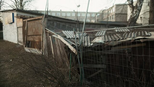 Wooden shed in yard with fence, metal roof, and composite material facade
