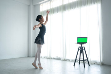 Little girl is practicing ballet in her bedroom at home, ballerina practicing classic choreography, ballet concept