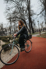A young and attractive businesswoman enjoying a bike ride in the park, showcasing style and confidence