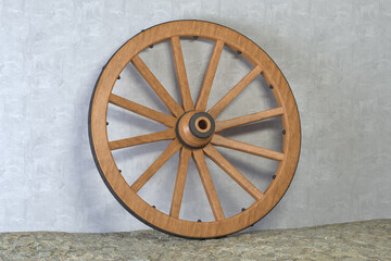 Old wooden wheel with black metal brackets and rivets