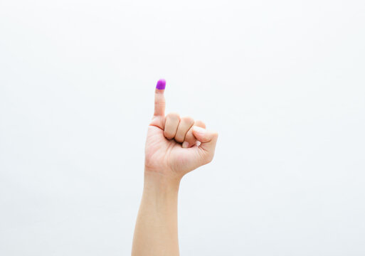 The little finger of a man's hand with blue ink patches isolated on a white background. blue ink spots from the fingers of Indonesia's presidential election (presidential election).