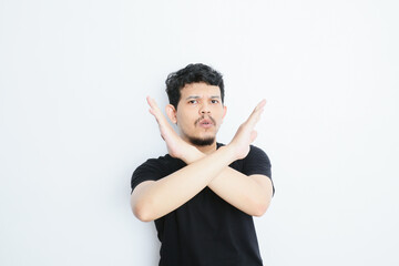an asian man shows a refusing gesture or a no sign