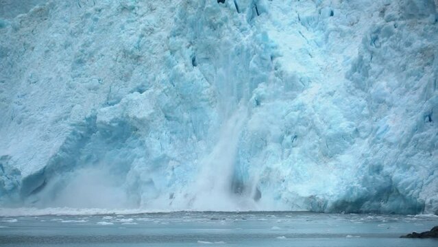 Glacier ice falling into sea