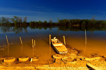 Fishing boat on the river Tisa in Novi Becej. - obrazy, fototapety, plakaty