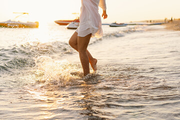 Gentle Waves Caressing the Shore at Golden Hour With a Person Walking Barefoot