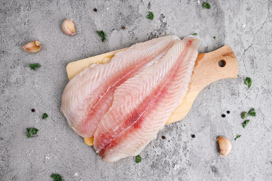 Top view of fresh fillet dory fish on wooden tray