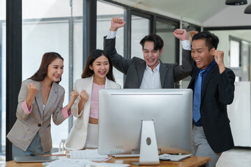 Smiling Asian businessman raising his hands Clapping happily at the table in the office Group of successful Asian business teams discuss cooperation Presentation and analysis of successful reports.