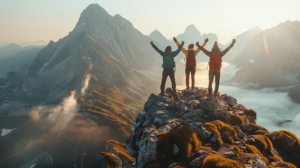 Keuken spatwand met foto Together overcoming obstacles with three people holding hands up in the air on mountain top , celebrating success and achievements © SHI
