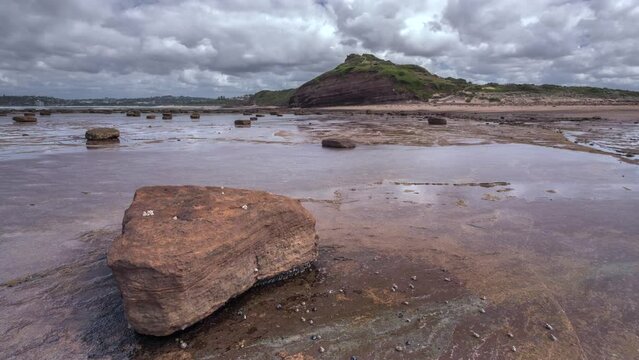 4K Timelapse of clouds racing over the Long Reef on Sydneys northern beaches. Be sure to notice the "speeding" zebra snails and black nerites!