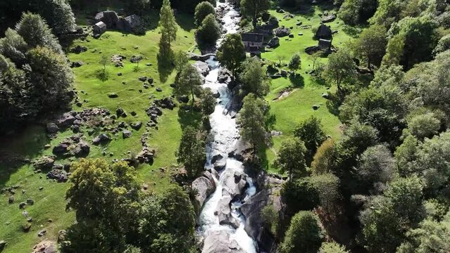 Rustic Foroglio houses by the cascading stream waterfall, Maggiatal, Tessin, Switzerland - aerial