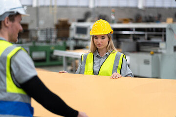 Caucasian businesswoman use checking Kraft paper at Kraft paper factory	 - 767563714