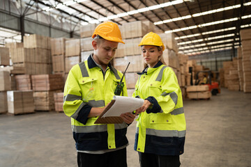 Caucasian businessman and woman checking wood stock with clipboard at timber warehouse	 - 767563738