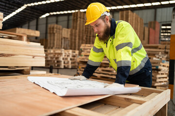 Caucasian businessman working with paper work and checking timber stock at warehouse	 - 767563749