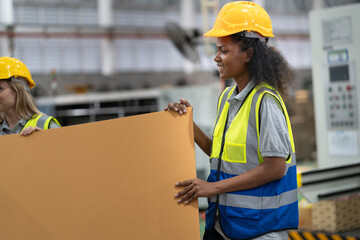 African American engineer or businesswoman checking Kraft paper stock in warehouse	 - 767563753