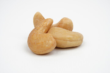 Closeup of three tasty cashew nuts isolated background