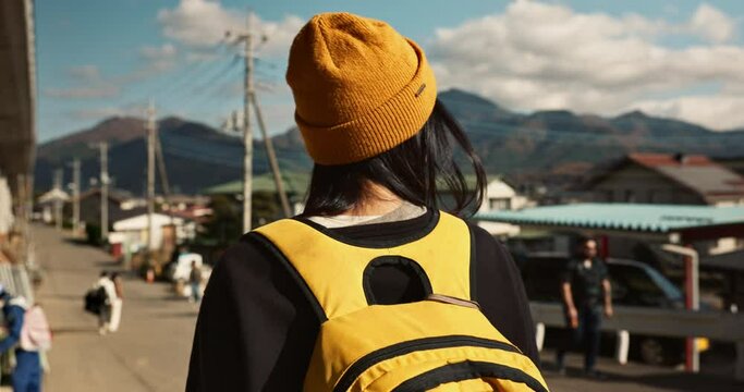 Japanese, woman at train station and travel, back view on commute or holiday and freedom outdoor. Railway, walking on platform and transportation, journey for adventure in China and weekend trip