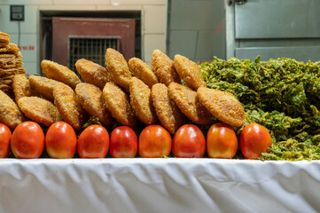 Khaja, an Indian deep-fried pastry, commonly filled with fruit or soaked with sugar syrup. Being sold at roadside, Jodhpur, Rajasthan, India.