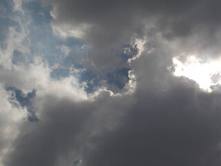 The sun hides behind dark clouds