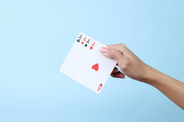 Hand Holds Hand Poker Cards Isolated Blue Background.
