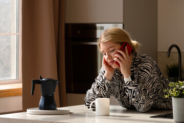 Woman talking on phone, enjoying coffee.