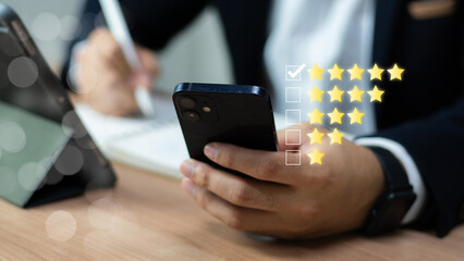 Customer satisfaction survey concept. Service experience rating, Satisfaction feedback review, good quality most. Person use smartphone to give excellent five-star ratings on virtual screen.