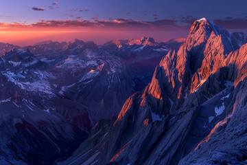 A breathtaking view of a mountain range at dawn, with the peaks illuminated by the first light of...