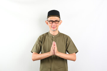 Portrait Asian Moslem Man with greetings and welcoming gestures, smiling face
