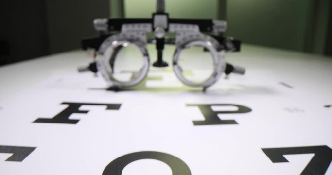 Vision screening device next to Snellen chart on table