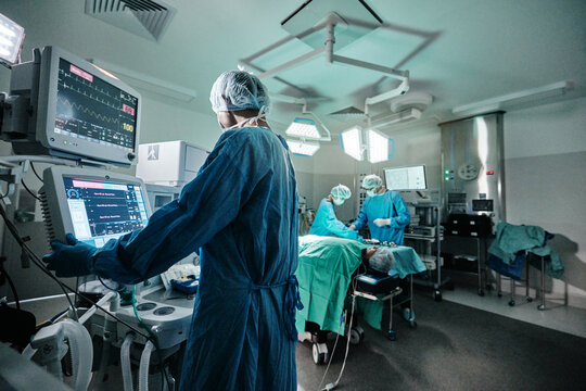 Screen, monitor or doctor in emergency surgery, professional care and hospital for support. Press, help and surgeon in operation or mask to check healthcare or track heart rate in medical results