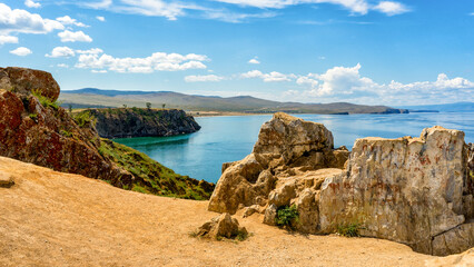 View from Olkhon island to Maloe More bay or Small Sea of lake Baikal. Picturesque summer landscape wuth rocks and hills, beautiful natural background. Discovering distant places of Earth. Siberia
