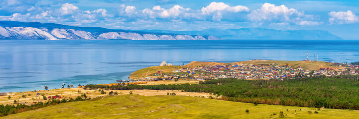 Panoramic view from hill to Khuzhir village of Olkhon island and Maloe More bay of lake Baikal, Russia. Picturesque summer landscape, beautiful background. Discovering distant places of Earth