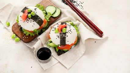 Poster Hybrid modern food. Sushi burger with salmon, white rice, avocado, cucumber. © bit24