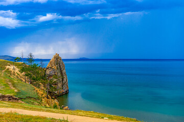 View to Baikal lake from Saraisky beach in Maloe More or Small Sea at Olkhon island. Beautiful summer landscape with turquoise water and upcoming thunderstorm. Siberia, Russia